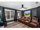 Theater room with tiered leather seating, large windows, and a ceiling fan, creating a cozy entertainment space at 9225 E Pine Valley Rd, Scottsdale, AZ 85260