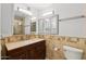 Bathroom showcasing updated vanity, mirrors, and a tiled shower at 11627 S Jokake St, Phoenix, AZ 85044