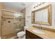 Bathroom featuring a tiled shower with glass doors and granite vanity at 11627 S Jokake St, Phoenix, AZ 85044