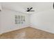 Bedroom with neutral paint and a window with white shutters at 11627 S Jokake St, Phoenix, AZ 85044