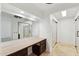 Dressing room with a vanity, large mirror and tile flooring at 11627 S Jokake St, Phoenix, AZ 85044