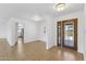 Inviting entryway featuring tile flooring, a modern light fixture, and a view into the bright open floor plan at 11627 S Jokake St, Phoenix, AZ 85044