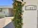 Close-up of the house number, 11627, with flowering vines adding a touch of nature at 11627 S Jokake St, Phoenix, AZ 85044