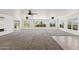 Bright and spacious living room featuring plush carpet, tile accents, recessed lights, and multiple windows overlooking the yard at 11627 S Jokake St, Phoenix, AZ 85044