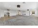 Expansive living room with plush carpet, tile accents, recessed lights, ceiling fans, and backyard access at 11627 S Jokake St, Phoenix, AZ 85044