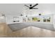 Large living room featuring plush carpet, tile accents, modern ceiling fans, and large windows overlooking the yard at 11627 S Jokake St, Phoenix, AZ 85044