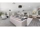 Large living room with stylish furnishings, a white sofa, and bright light from the large windows at 11627 S Jokake St, Phoenix, AZ 85044
