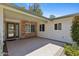 Inviting covered patio featuring tiled flooring, decorative stone accents, and an attractive glass paneled door at 11627 S Jokake St, Phoenix, AZ 85044