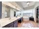 Bright bathroom featuring dual sinks, a walk-in closet, and a soaking tub with natural light at 14818 N 10Th St, Phoenix, AZ 85022