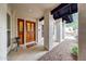 Inviting front porch showcasing the wood door with stained glass and stucco pillars at 14818 N 10Th St, Phoenix, AZ 85022
