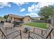 A paver patio, outdoor dining and seating, and well-maintained grass are great for entertaining at 17845 W Calavar Rd, Surprise, AZ 85388