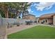 Paver patio and lush grass provide a fantastic entertaining area in this landscaped backyard at 17845 W Calavar Rd, Surprise, AZ 85388