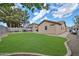 A lush lawn provides a beautiful open space in this well-manicured backyard at 17845 W Calavar Rd, Surprise, AZ 85388