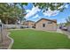 A lush lawn provides a beautiful open space in this well-manicured backyard at 17845 W Calavar Rd, Surprise, AZ 85388