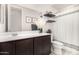 Bathroom features a large mirror, dark wood vanity, and modern fixtures for a clean aesthetic at 19875 W Badgett Ln, Litchfield Park, AZ 85340