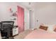 Comfortable bedroom featuring a bed, a study, and a bright pink curtain at 19875 W Badgett Ln, Litchfield Park, AZ 85340