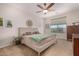 Bright bedroom with a plush bed, neutral tones, and a view to the outdoors at 19875 W Badgett Ln, Litchfield Park, AZ 85340