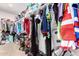 Walk-in closet fully equipped with shelves, hanging rods, and neatly organized items at 19875 W Badgett Ln, Litchfield Park, AZ 85340