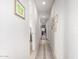 Hallway features neutral walls, symmetrical design, and clean lines, creating a calming transition between rooms at 19875 W Badgett Ln, Litchfield Park, AZ 85340