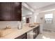 Well-equipped kitchen with stainless steel appliances, ample counter space, and dark wood cabinetry at 19875 W Badgett Ln, Litchfield Park, AZ 85340