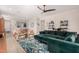Inviting living room with a comfortable emerald green sectional, modern decor and open access to the dining area at 19875 W Badgett Ln, Litchfield Park, AZ 85340