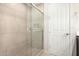 Tiled walk-in shower with glass door and chrome hardware inside the bathroom at 19875 W Badgett Ln, Litchfield Park, AZ 85340