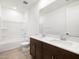 Bright bathroom featuring double vanity, modern fixtures, and shower over tub at 37111 W Parador Ln, Maricopa, AZ 85138