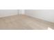 An empty bedroom showcasing neutral carpet, base trim, and a door on the right at 37111 W Parador Ln, Maricopa, AZ 85138
