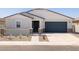 Attractive single-story home featuring desert landscaping and a secure gated entry at 37111 W Parador Ln, Maricopa, AZ 85138