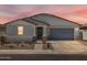 Charming single-story home with a well-manicured front yard and a two-car garage at 37111 W Parador Ln, Maricopa, AZ 85138