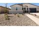 Inviting front yard with desert landscaping and a charming gated entrance at 37111 W Parador Ln, Maricopa, AZ 85138