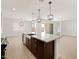 Open concept kitchen with large island, granite countertops, and modern pendant lighting at 37111 W Parador Ln, Maricopa, AZ 85138