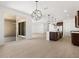 Open-concept living room featuring tile floors, modern lighting, and seamless patio access at 37111 W Parador Ln, Maricopa, AZ 85138