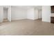 Open-concept living space with tile floors, multiple entryways, and neutral paint at 37111 W Parador Ln, Maricopa, AZ 85138