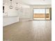 Bright, open-concept living space featuring tile floors, views of the backyard patio, and a modern open kitchen at 37111 W Parador Ln, Maricopa, AZ 85138