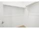 Empty walk-in closet with white wire shelving and carpet flooring at 37111 W Parador Ln, Maricopa, AZ 85138