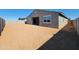 A spacious backyard with block wall providing privacy and a covered patio area for outdoor enjoyment at 37151 W Parador Ln, Maricopa, AZ 85138