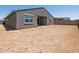 Exterior rear view with a large dirt backyard and concrete block wall at 37151 W Parador Ln, Maricopa, AZ 85138