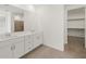 Bathroom featuring double vanity, tile flooring and a glimpse into the closet at 37151 W Parador Ln, Maricopa, AZ 85138