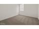 Inviting bedroom with plush carpet, a bright window, and electrical outlets at 37151 W Parador Ln, Maricopa, AZ 85138