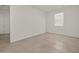A well lit bedroom features neutral tile flooring and a single window at 37151 W Parador Ln, Maricopa, AZ 85138