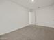 This bedroom features neutral carpeting and a minimalist design at 37151 W Parador Ln, Maricopa, AZ 85138