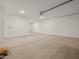 A spacious garage features a large roll-up door and epoxy flooring at 37151 W Parador Ln, Maricopa, AZ 85138
