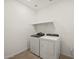 The laundry room features a new, modern washer and dryer at 37151 W Parador Ln, Maricopa, AZ 85138