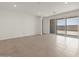 Bright living area with tile flooring and access to a private outdoor space at 37151 W Parador Ln, Maricopa, AZ 85138