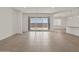 Open living area with a sliding glass door and bar access to the modern kitchen at 37151 W Parador Ln, Maricopa, AZ 85138