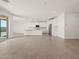 Spacious living area flows into a modern kitchen with stainless steel appliances at 37151 W Parador Ln, Maricopa, AZ 85138