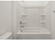 Clean and functional bathroom featuring a shower-tub combo with built-in shelves at 37151 W Parador Ln, Maricopa, AZ 85138
