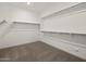 Spacious walk-in closet featuring multiple shelves and rods for optimal organization and storage at 37151 W Parador Ln, Maricopa, AZ 85138
