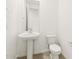 This charming bathroom features a pedestal sink and toilet with tiled floors and a mounted mirror at 4032 S 176Th Dr, Goodyear, AZ 85338